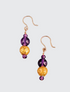 Amethyst Glow Earrings featuring faceted and smooth round amethyst beads along with 23 karat hand gilded round lava stone. The earrings are 1.50" and the drop is 1". They are on 14 karat gold filled french wire for pierced ears.