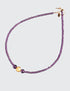 Amethyst Glow Necklace. Handcrafted with exquisite attention to detail, this elegant piece features stunning amethyst gemstones complemented by hand-gilded 23 karat gold leaf on lava stone center bead. It measures 17-inch in length and is finished with a 14 karat gold-filled toggle clasp.