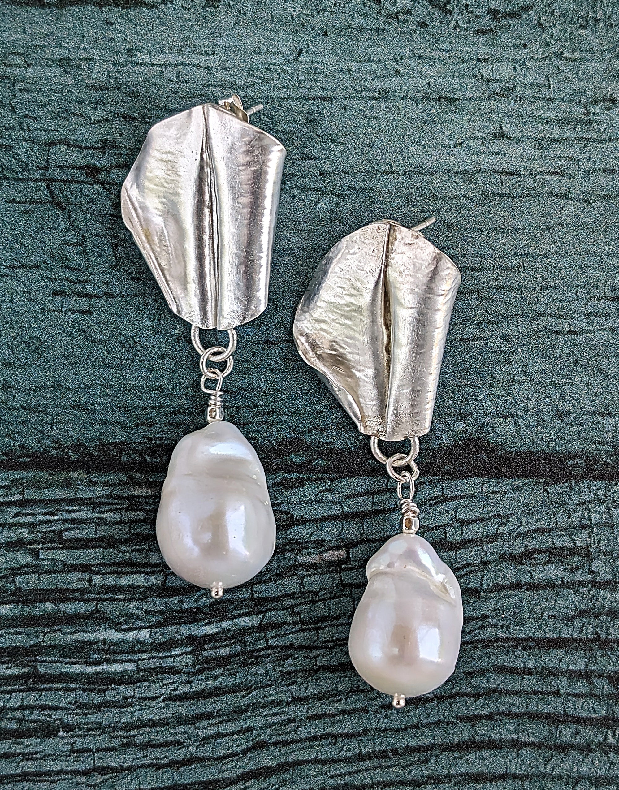 White Baroque pearl drop earrings with sterling silver fold form and hand hammered leaf design.