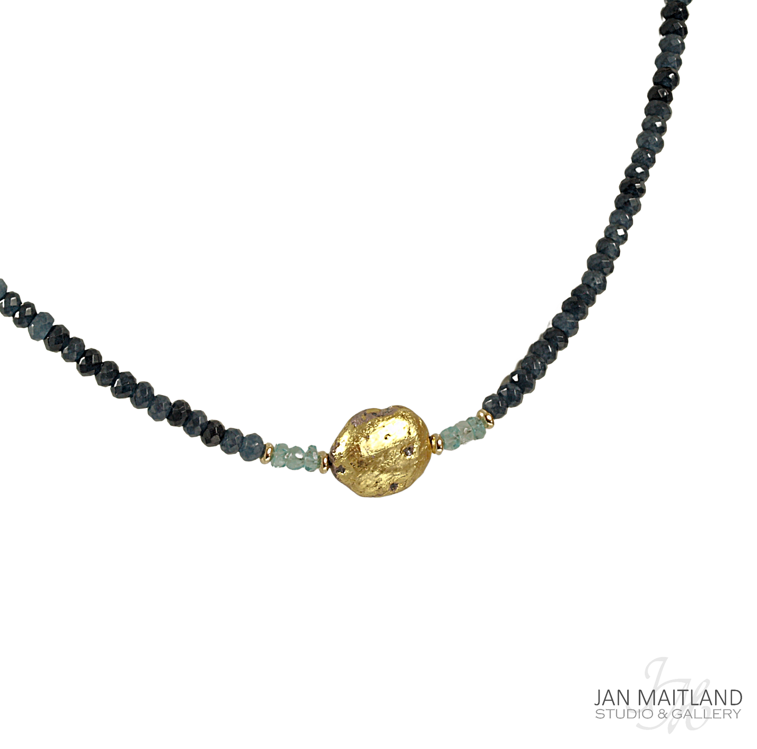 A gold-colored pendant necklace with blue faceted onyx and aqua apatite stones, displayed against a black background.