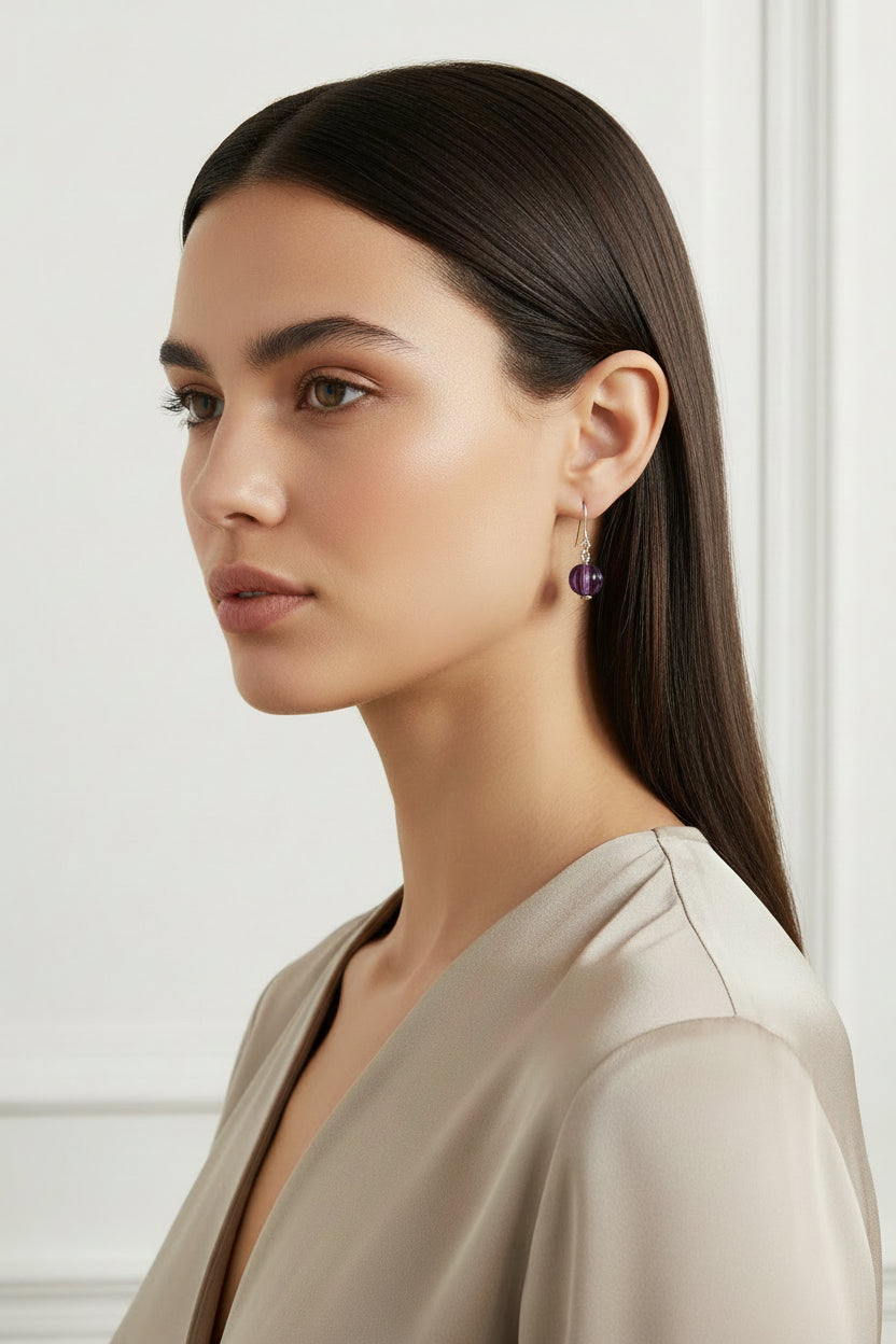 Purple beaded earring profiled on a model.