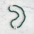 An image of a silver toggle clasp on a necklace with hand-knotted chrysocolla beads and lampwork glass.
