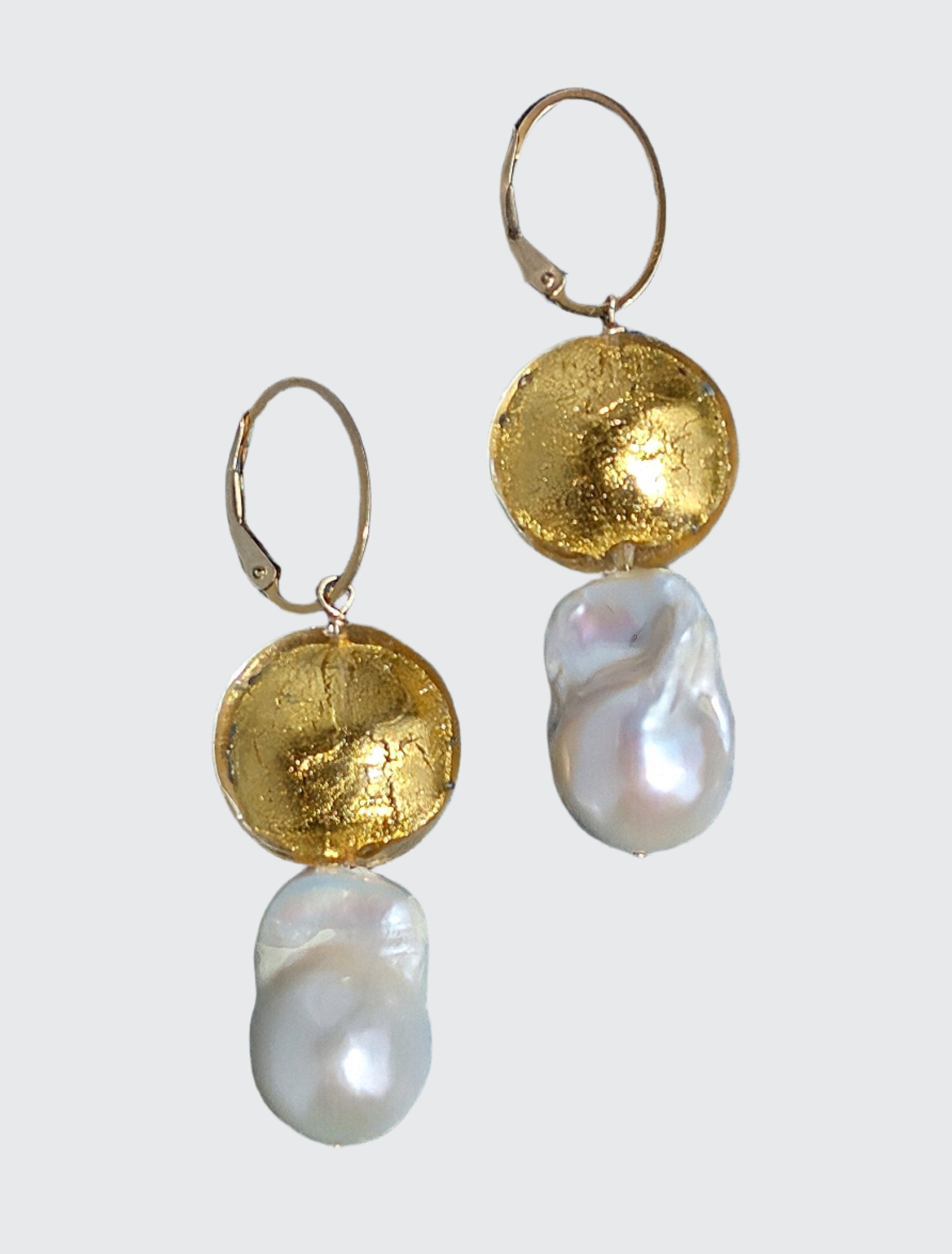Adorn yourself with the elegance of luxurious white baroque pearls, paired with 24 Karat gold foil and lamp work Venetian glass bead.   The pearls boast a gorgeous luster with the compliment of the gold dome shaped gold in the design. The dangle earrings measure 2.25" in length, They make a statement, are fun to wear, and can be worn with dressy or casual wear.