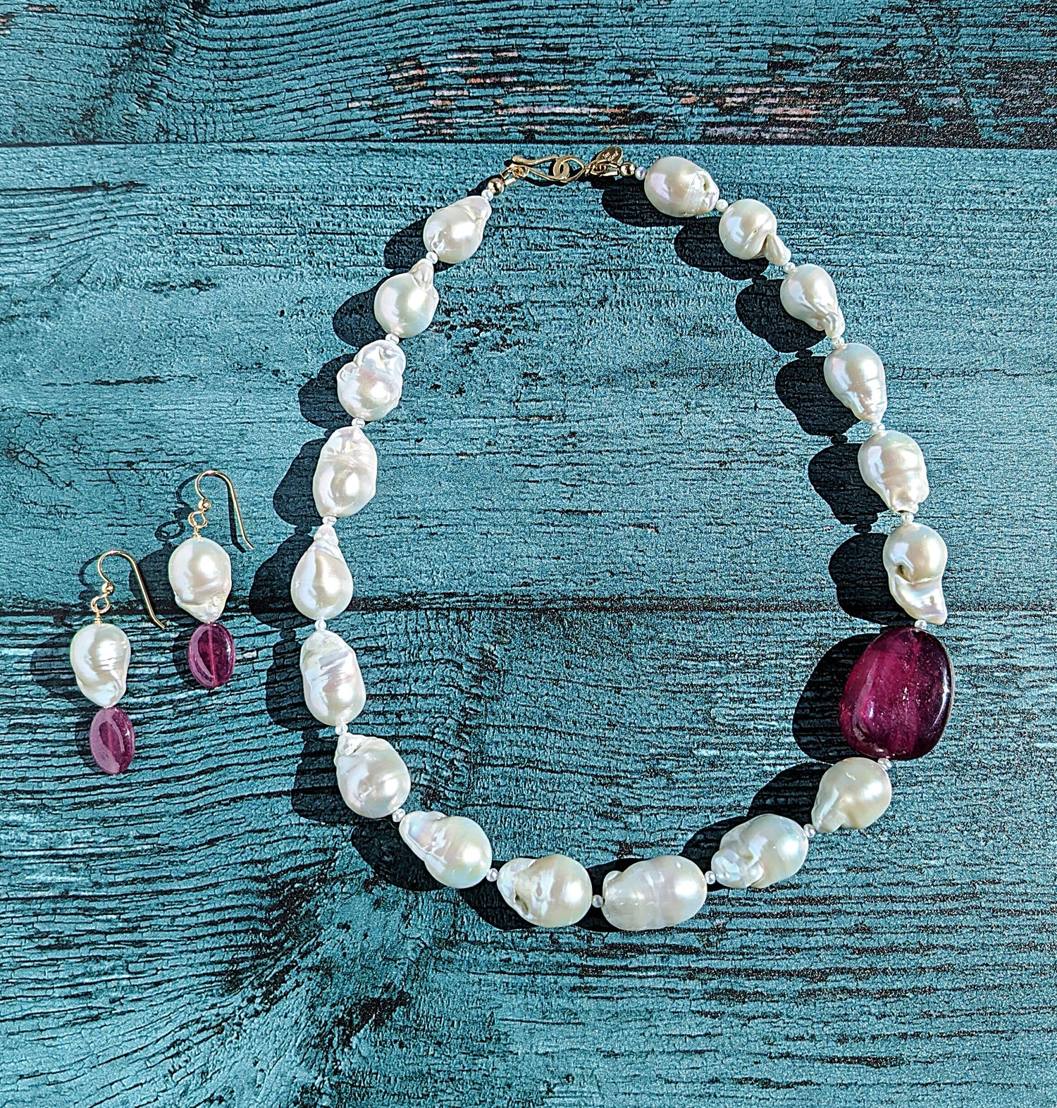 Baroque Pearl and Ruby necklace and dangle earrings with 14 karat gold earring wire and 14 karat necklace clasp.