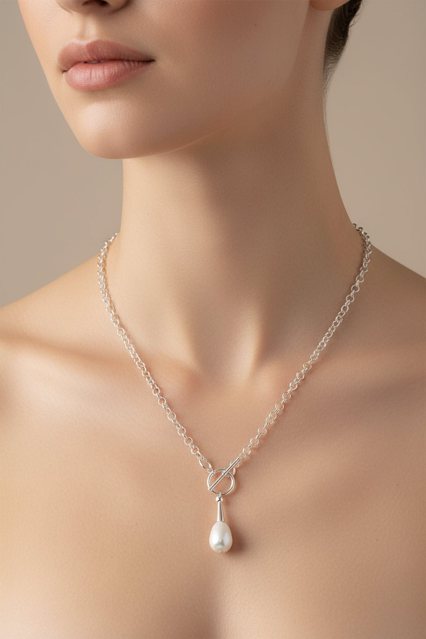 Silver necklace with a pearl pendant on a model
