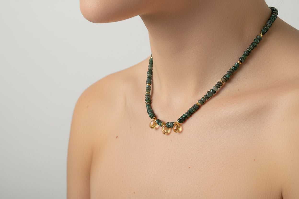Emerald and citrine necklace on an elegant model.