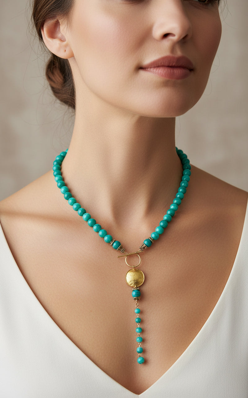 Green agate beaded necklace with a gold pendant on a model.