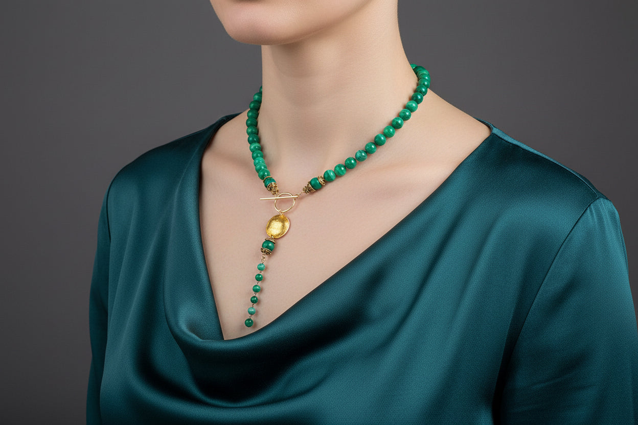 Necklace with green beads and gold accents on a model.