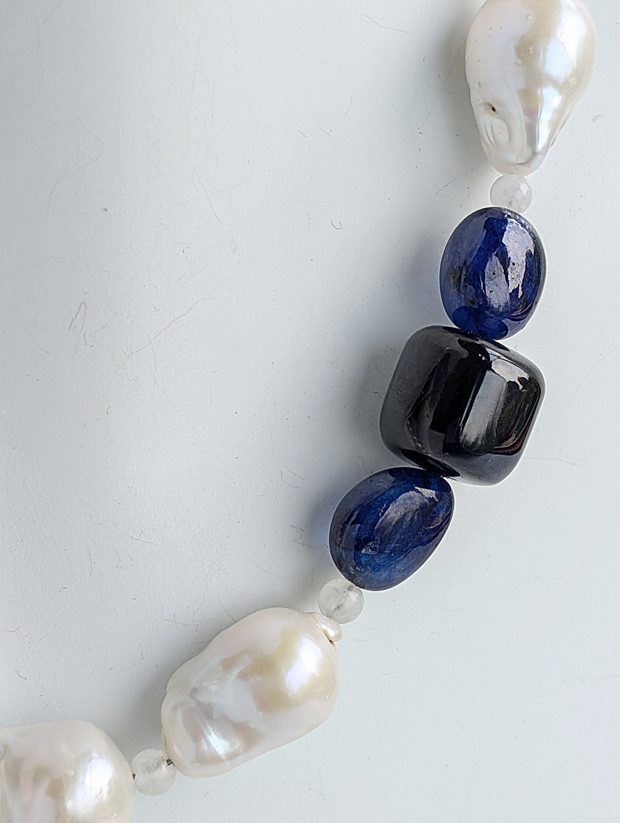 A close-up of the three smooth blue sapphires on the necklace.