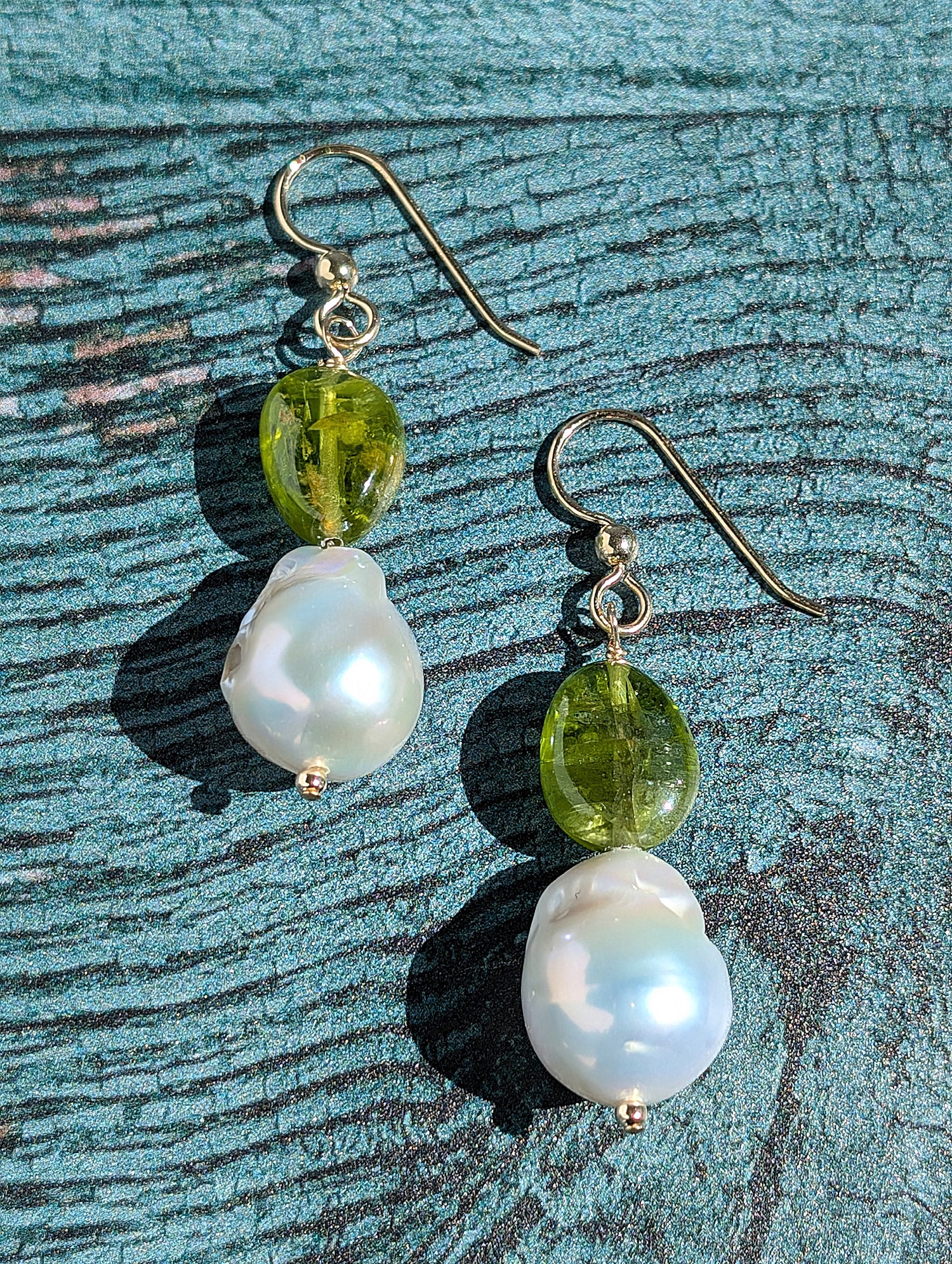 Peridot and Baroque Pearl earrings on 14 Karat gold earring wire. The dangle earrings measure 2".