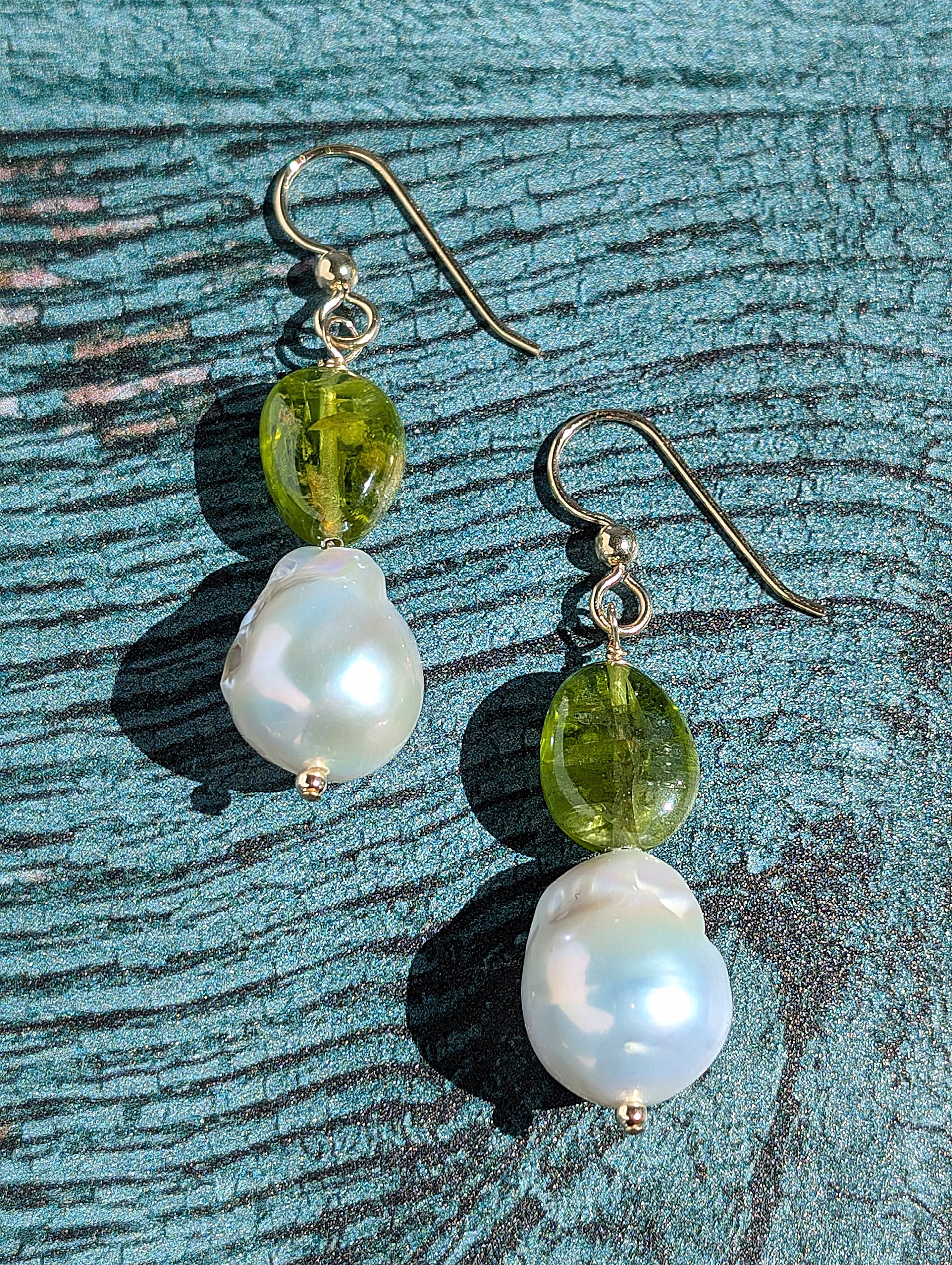 Peridot and Baroque Pearl earrings on 14 Karat gold earring wire. The dangle earrings measure 2".