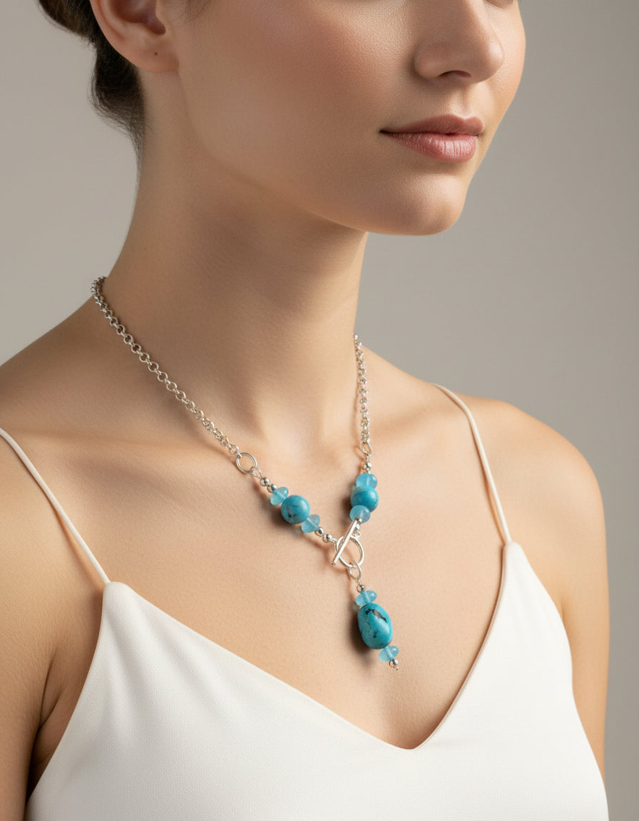Turquoise and silver toggle necklace on a model.