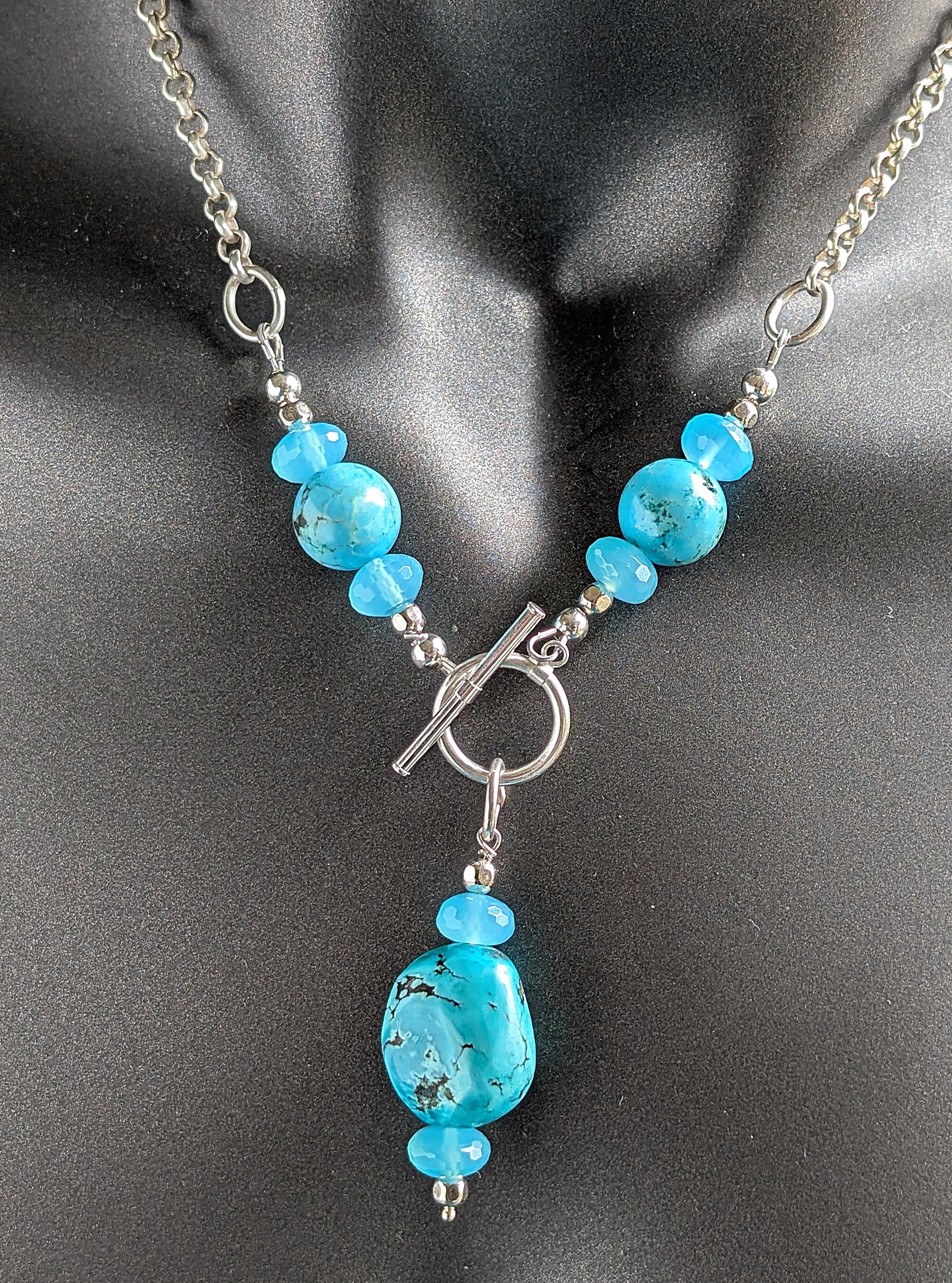 Necklace with turquoise beads on a dark background