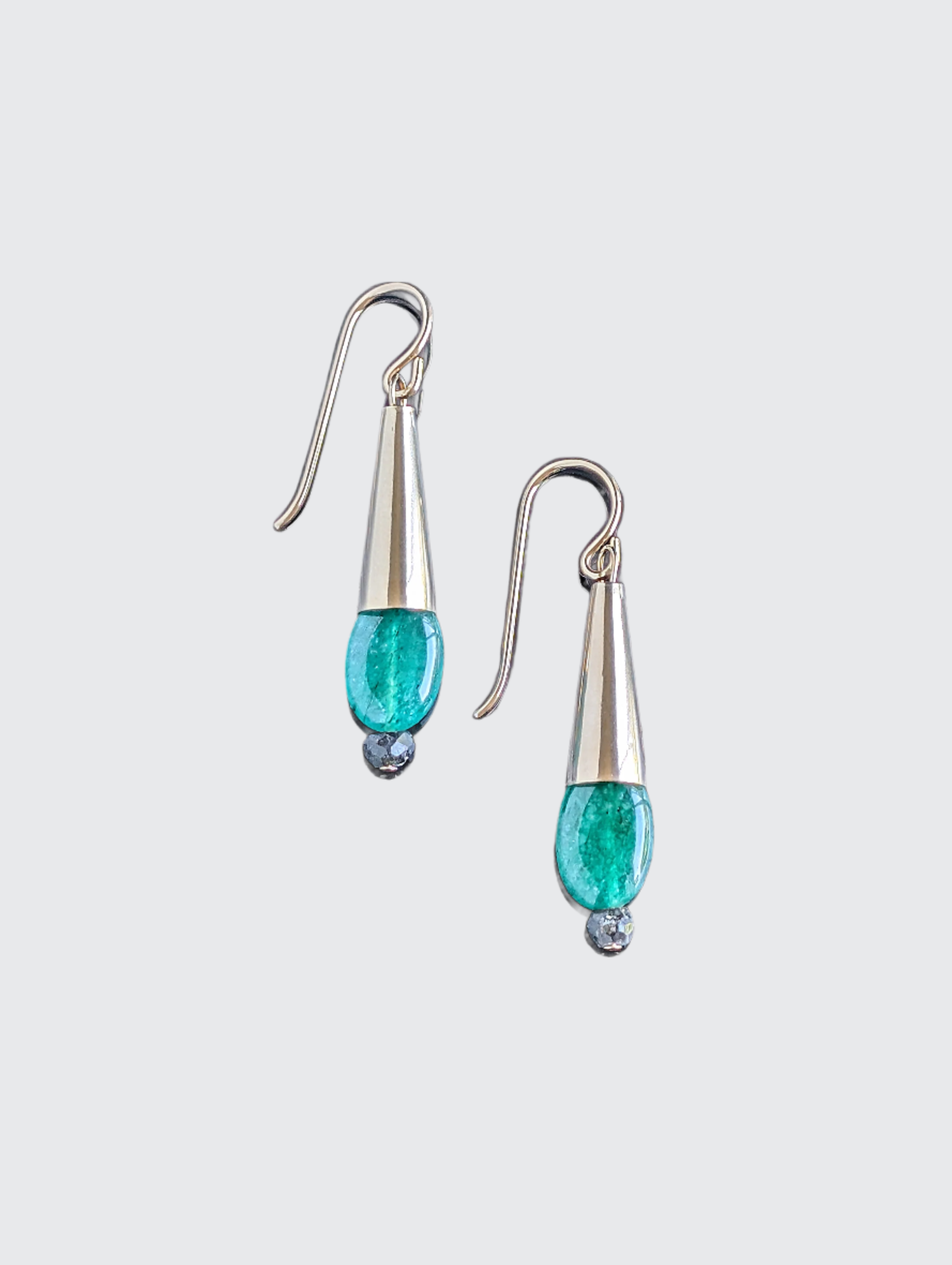A pair of emerald drop earrings with 14 karat gold filled coned-shaped design, using French hook wires for attachment.