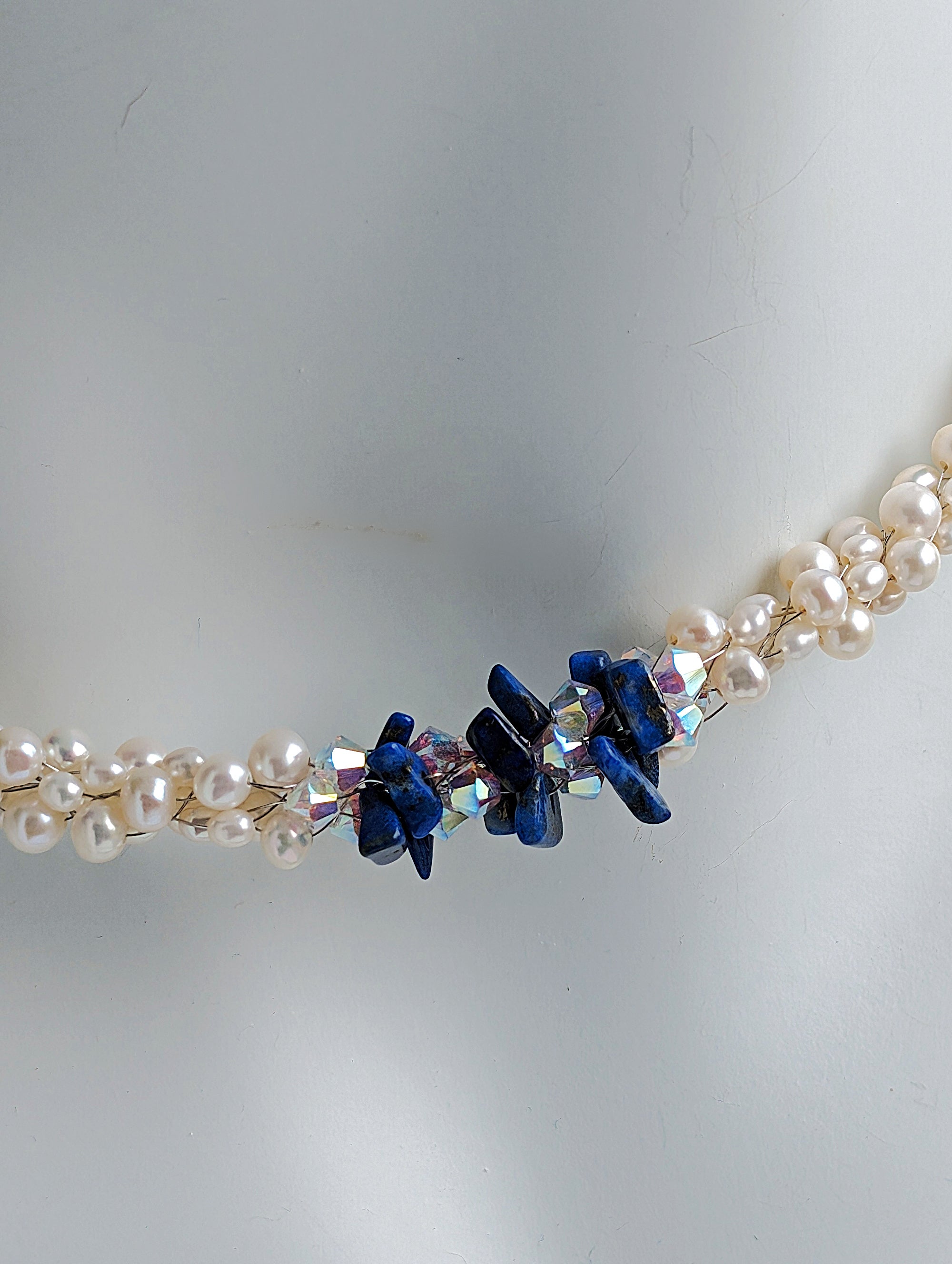 "Something Blue" necklace is a combination of glowing cultured freshwater pearls with center stones in gorgeous lapis lazuli and sparkly Swarovski crystals. The beads are braided on 8 strands to create an elegant heirloom-quality necklace