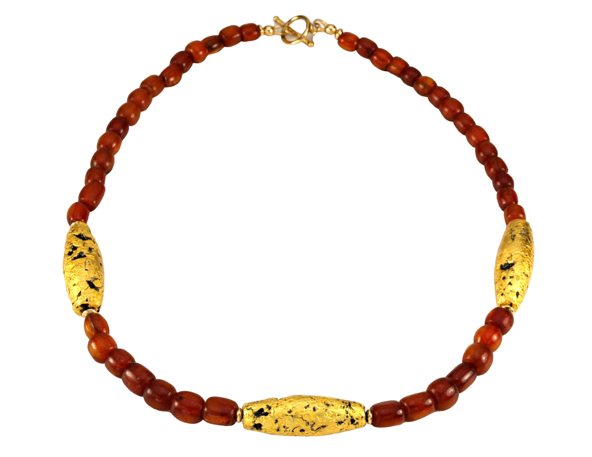 Necklace with three gold gilded oblong lava beads evenly spaced between pecan colored amber beads laid out in a circle with closed toggle clasp.