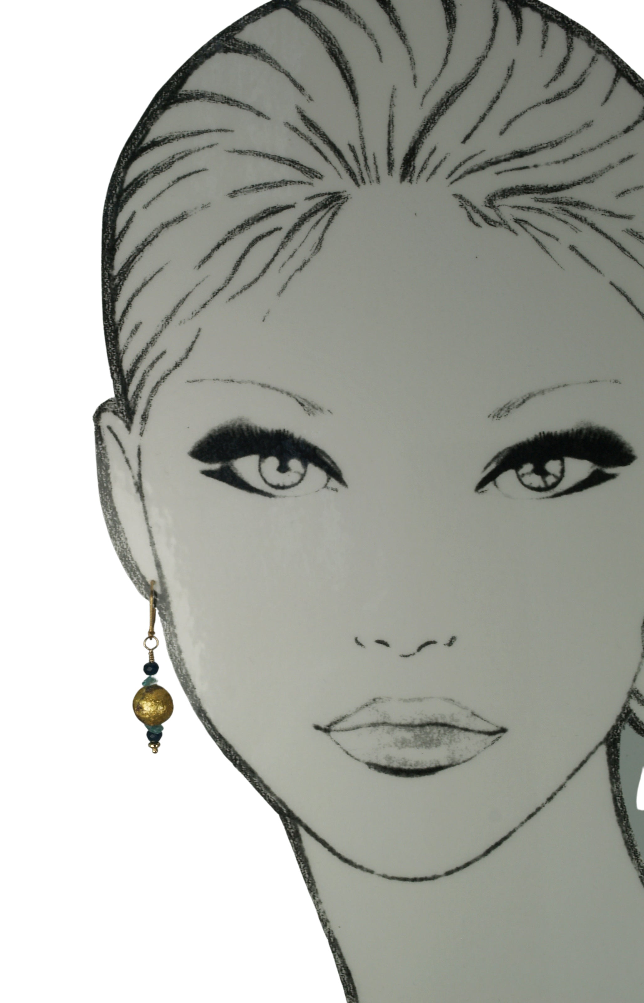 4mm faceted dark blue onyx, aqua apatite, and 23 karat gold gilded round lava stone with 14-karat gf leverback earrings on a mannequin.