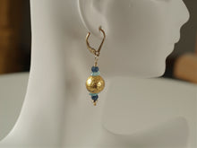 Load image into Gallery viewer, 4mm faceted dark blue onyx, aqua apatite, and 23 karat gold gilded round lava stone with 14-karat gf leverback earrings on a small mannequin.