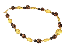 Load image into Gallery viewer, Hand made necklace with 23 karat gold gilded lava stones, lamp work bronze Czech glass, and 14 karat gold filled small round beads. The necklace is finished with 14 karat gold filled toggle clasp. Necklace is facing to the right.
