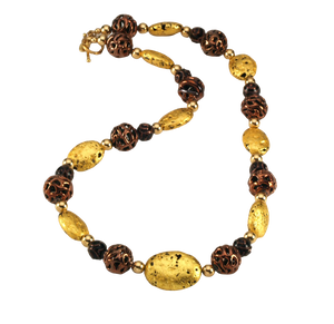 Hand made necklace with 23 karat gold gilded lava stones, lamp work bronze Czech glass, and 14 karat gold filled small round beads. The necklace is finished with 14 karat gold filled toggle clasp.