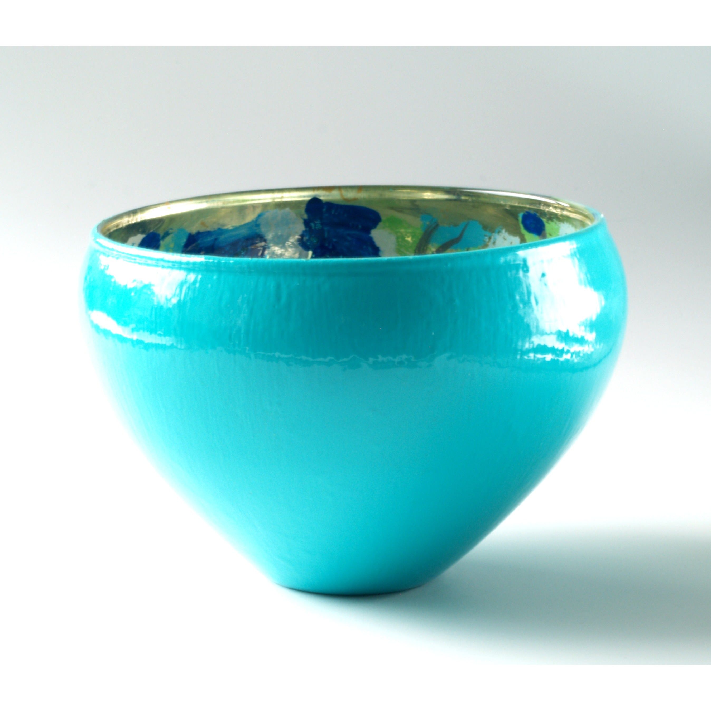 Turquoise glass bowl on white background.