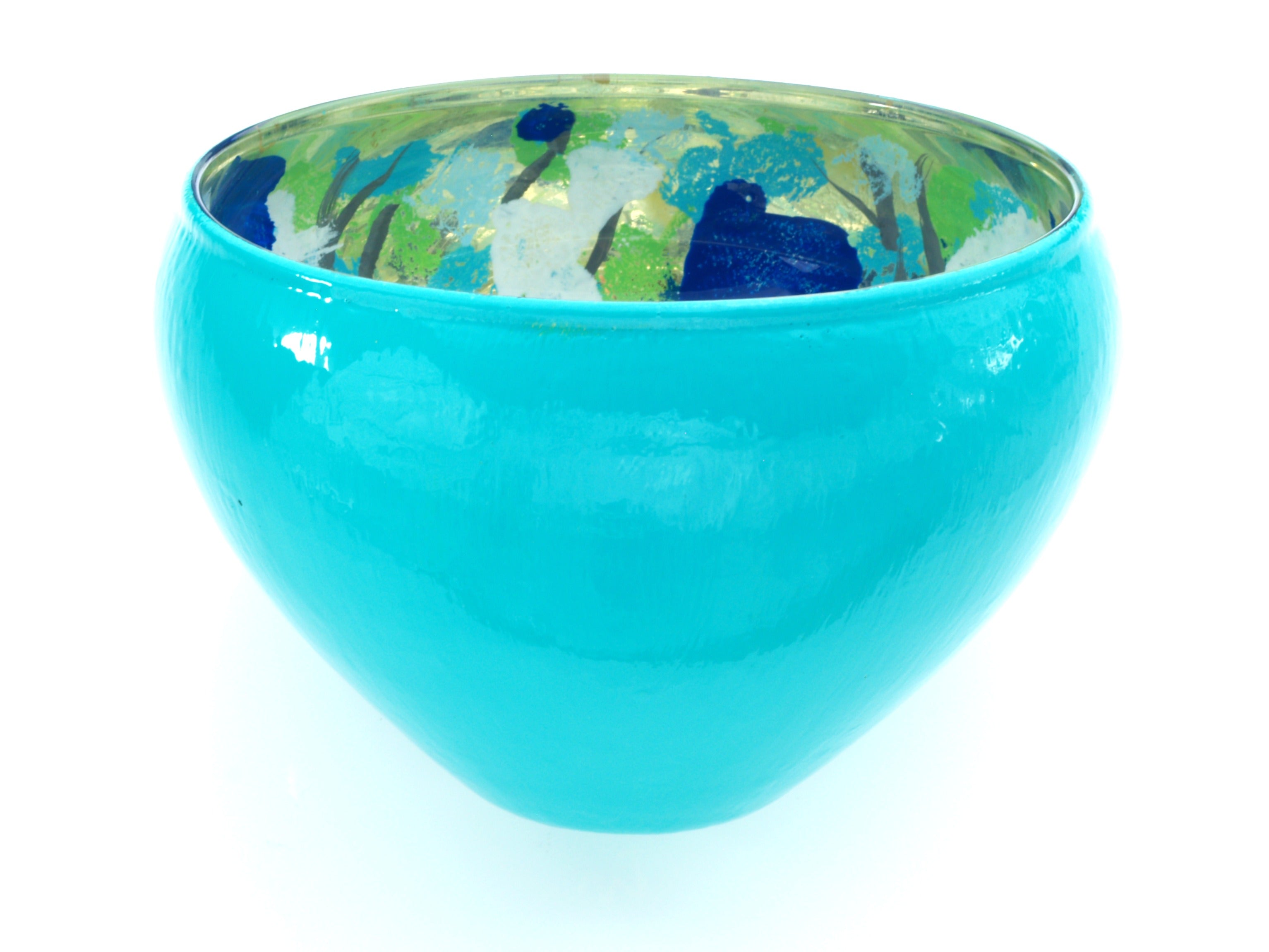 Turquoise glass bowl on white background.