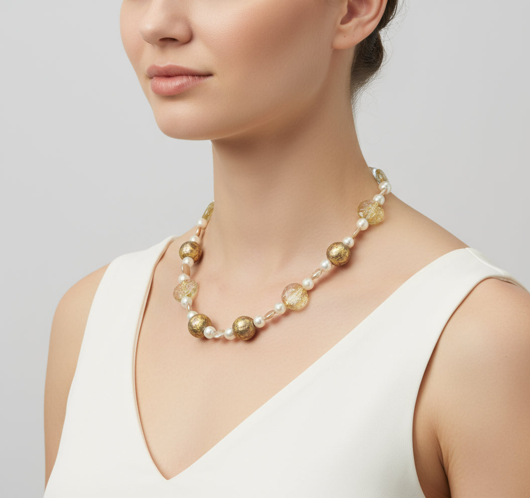 Pearl necklace with gold gilded beads, gold lampwork Czech glass beads, featured on a model.