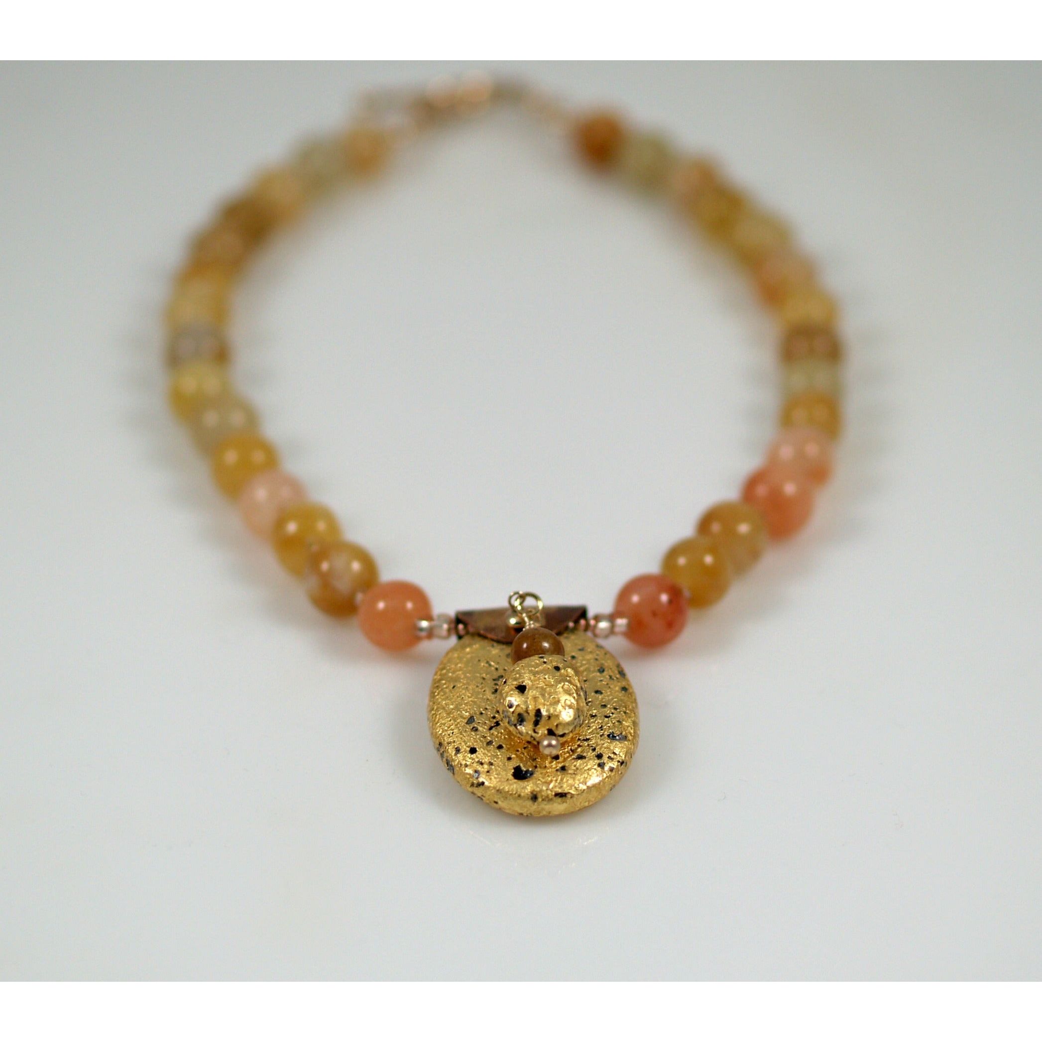 gold gilded on lava pendant and yellow jade necklace