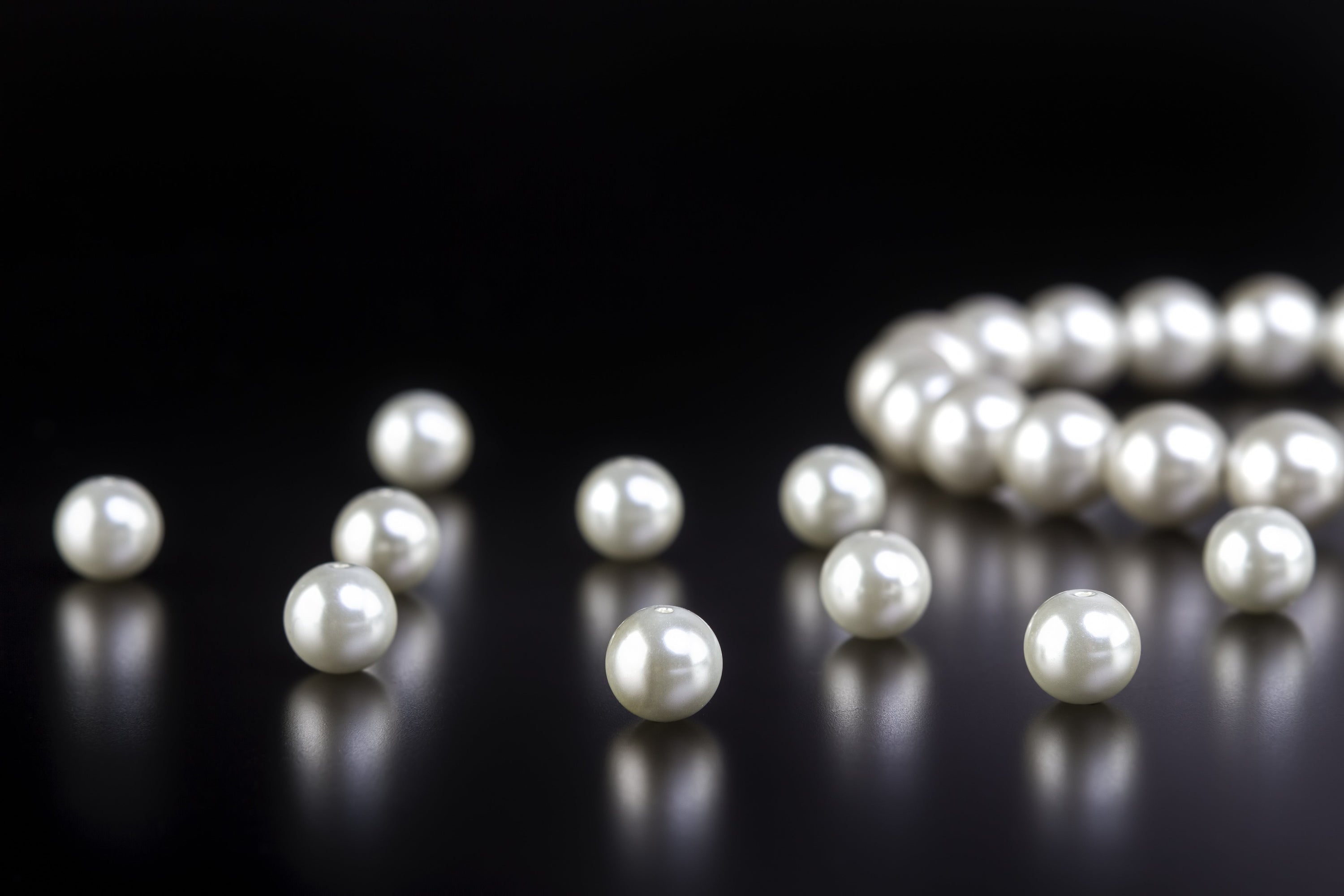 Photo of loose white pearls.