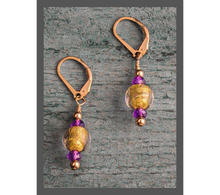 Load image into Gallery viewer, Introducing our stunning &quot;Amethyst Allure&quot; earrings, embellished with exquisite lamp work gold glass beads, faceted sparkly amethysts, and finished with 14 Karat gold-filled lever back earring wires. They measure 1.5&quot;