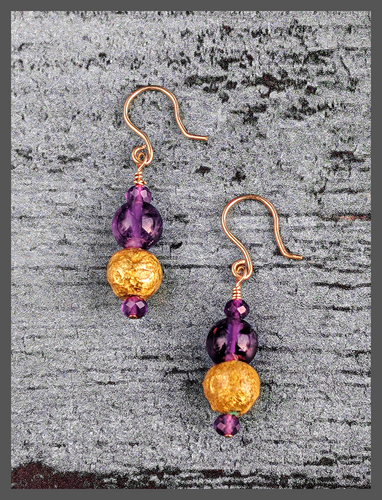 Amethyst Glow Earrings featuring faceted and smooth round  amethyst beads along with 23 karat hand gilded round lava stone. The earrings are 1.50