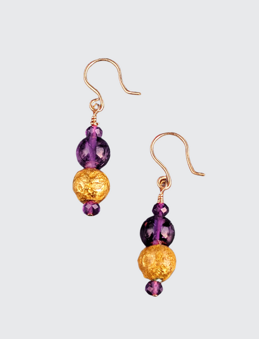 Amethyst Glow Earrings featuring faceted and smooth round  amethyst beads along with 23 karat hand gilded round lava stone. The earrings are 1.50