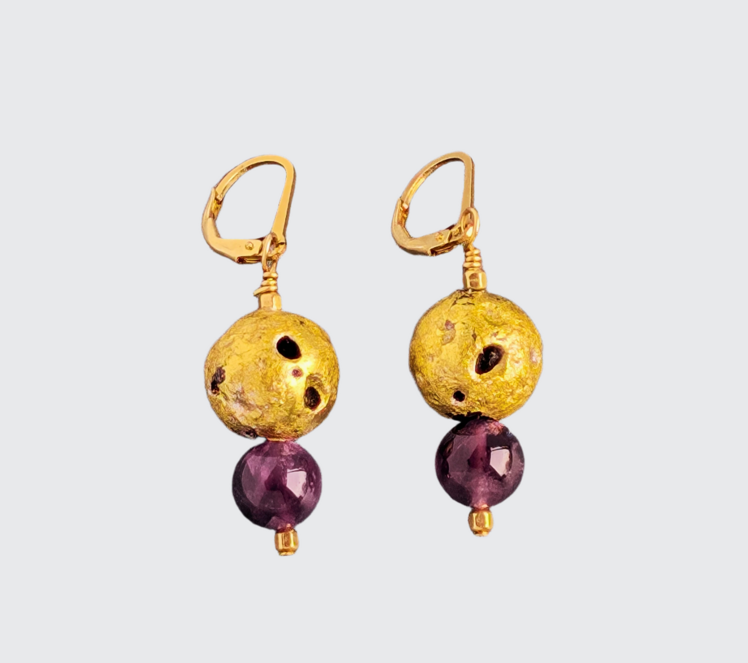 Amethyst Nugget Glow Earrings  - Amethyst, 23-Karat Gold Leaf On Stone  Hand-gilded lava stone with 23-karat gold leaf, smooth amethyst beads, and 14-karat gold-filled lever back findings.  The dangle drop equals = 1.5&quot; (3.81cm)