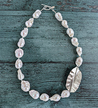 Load image into Gallery viewer, White Baroque pearl and silver necklace with hammered and fold form leaf design in silver with small silver beads in between each pearl. Necklace is finished with silver toggle clasp and designer tag.
