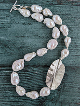 Load image into Gallery viewer, White Baroque pearl and silver necklace with hammered and fold form leaf design in silver with small silver beads in between each pearl. Necklace is finished with silver toggle clasp and designer tag.