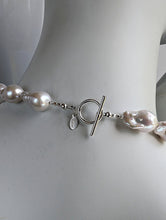 Load image into Gallery viewer, Back of White Baroque pearl necklace showing sterling silver toggle clasp and designer signature tag.