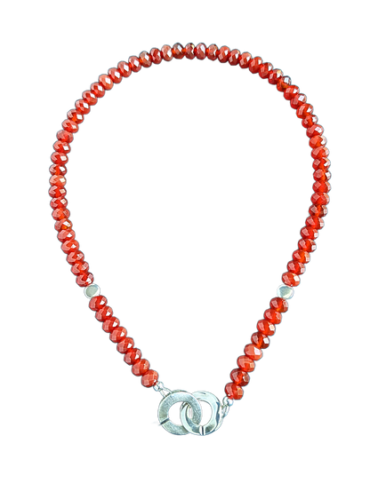 Carnelian red beads and sterling silver necklace on a white background.
