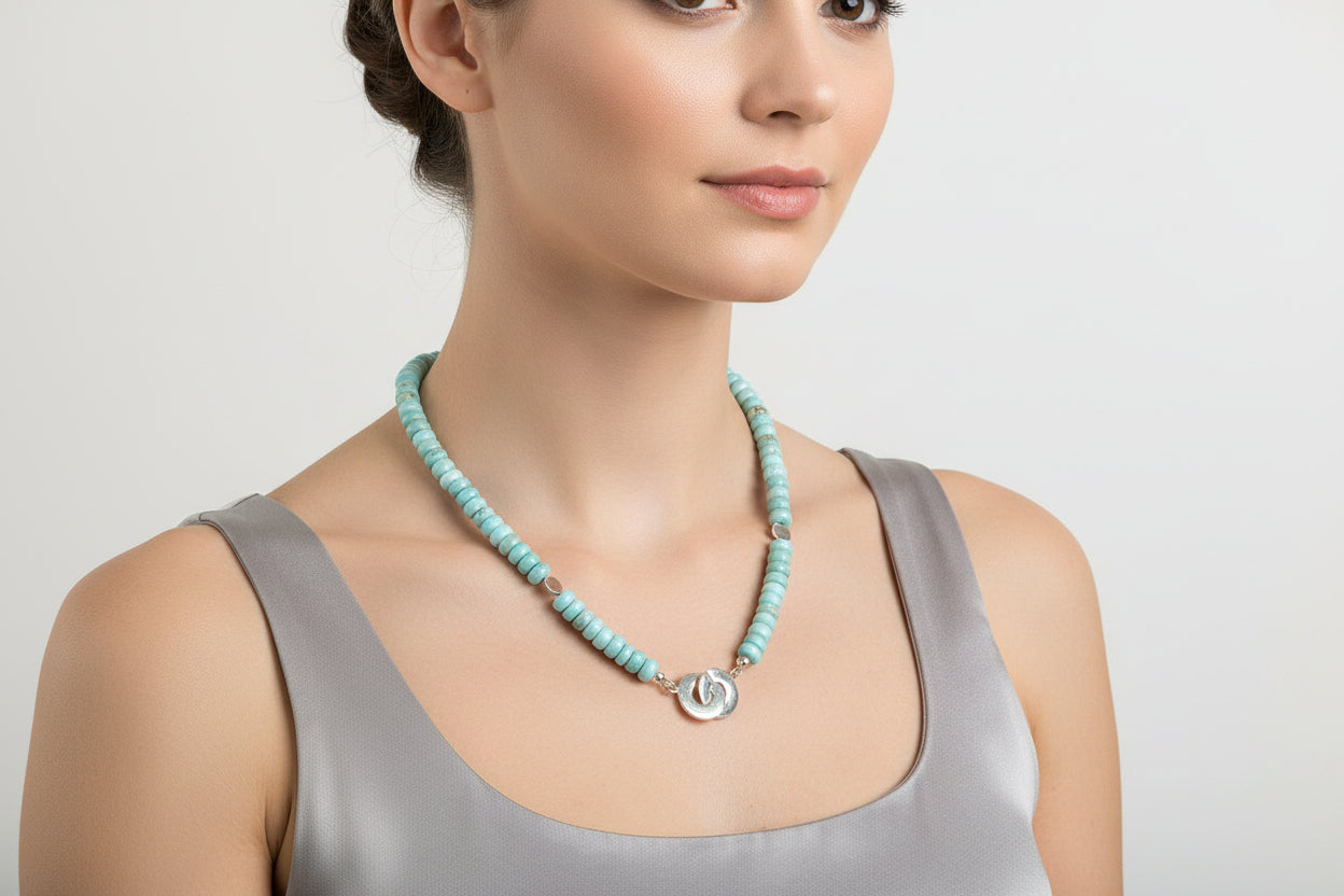 Necklace with blue larimar beads and silver clasp on a model.