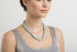 Necklace with blue larimar beads and silver clasp on a model.