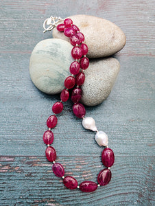 Ruby and Baroque Pearl Necklace - "Romancing the Ruby" necklace. This exquisite piece features cabochon smooth rubies, lustrous Baroque pearls, sterling silver beads, a charming toggle clasp, and a signature tag by the artist. With a length of 18 inches.