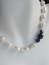 Load image into Gallery viewer, A close up of the baroque pearl, moonstone and sapphires on the necklace pictured on a life size mannequin neck.