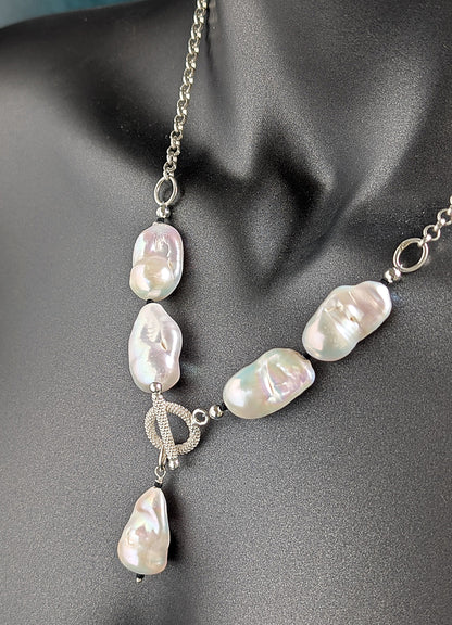 Pearl necklace with silver chain on a mannequin