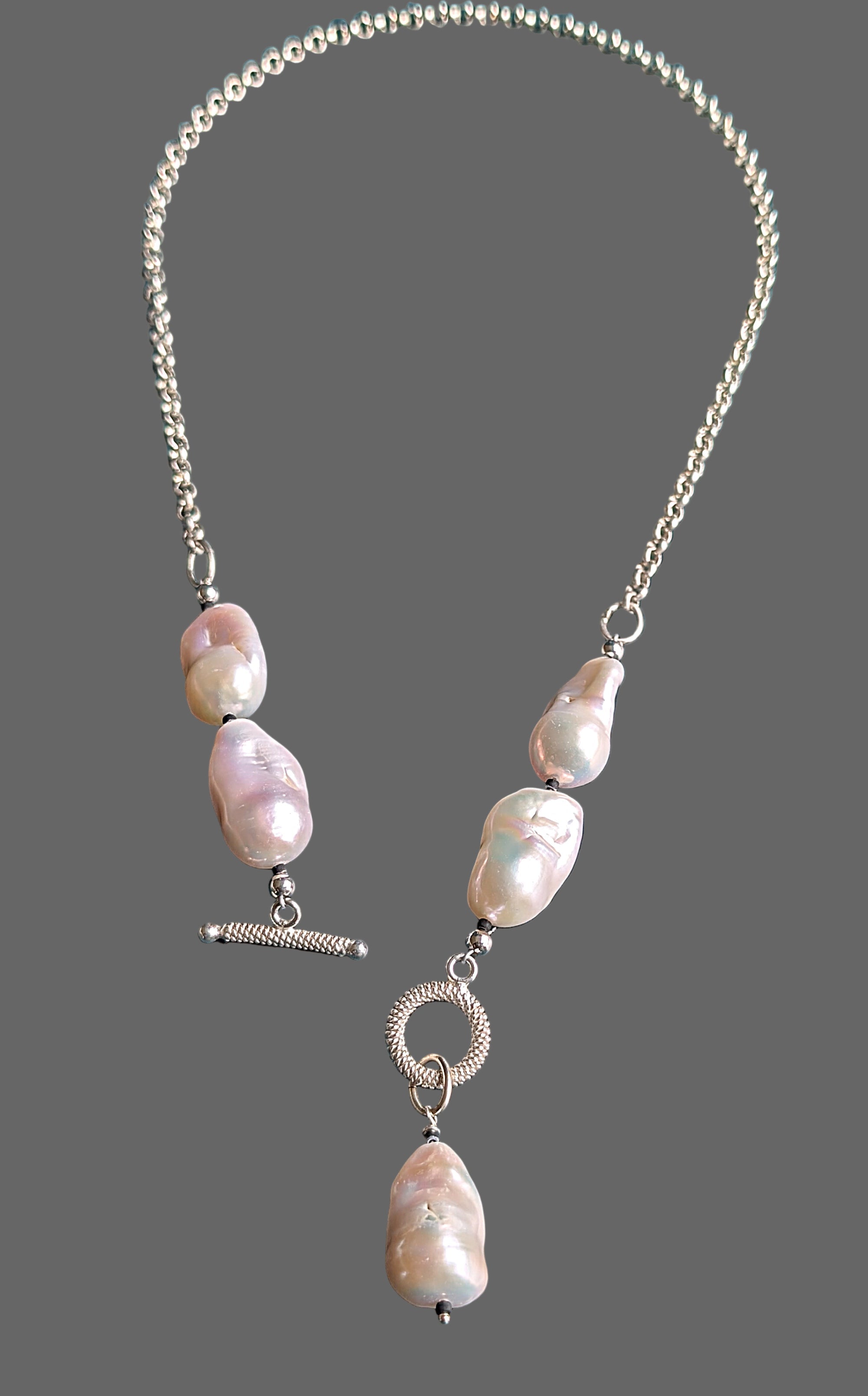 Necklace with white pearls on a grey background