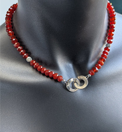 Necklace with red beads and silver clasp on a mannequin neck