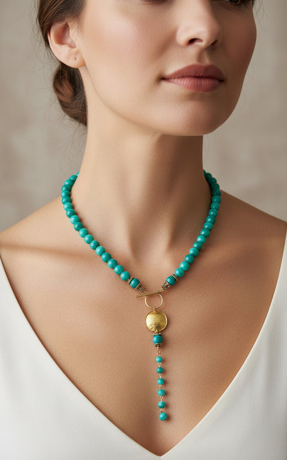 Green agate beaded necklace with a gold pendant on a model.