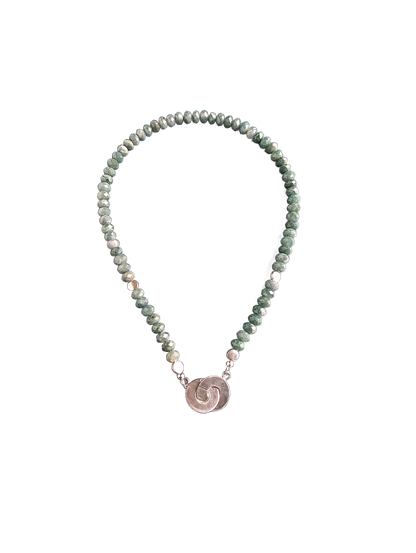 Necklace with beaded chain and circular pendant on a white background