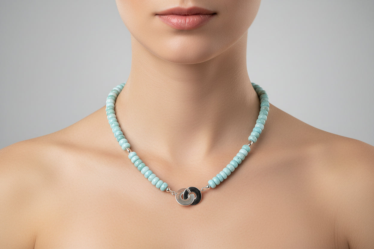 Blue Larimar beaded necklace with silver clasp on a model.