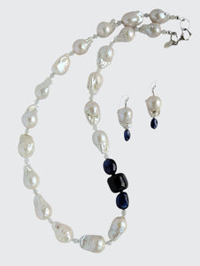 Showing Baroque Pearl and Sapphire Necklace with matching earrings. The necklace is finished with sterling silver heart clasp, earrings are finished with sterling silver French hook earring wire.