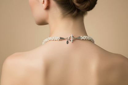 On a model showing the sterling silver toggle clasp and artist signature tag