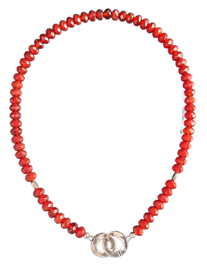 Necklace with red beads and silver clasp on a white background